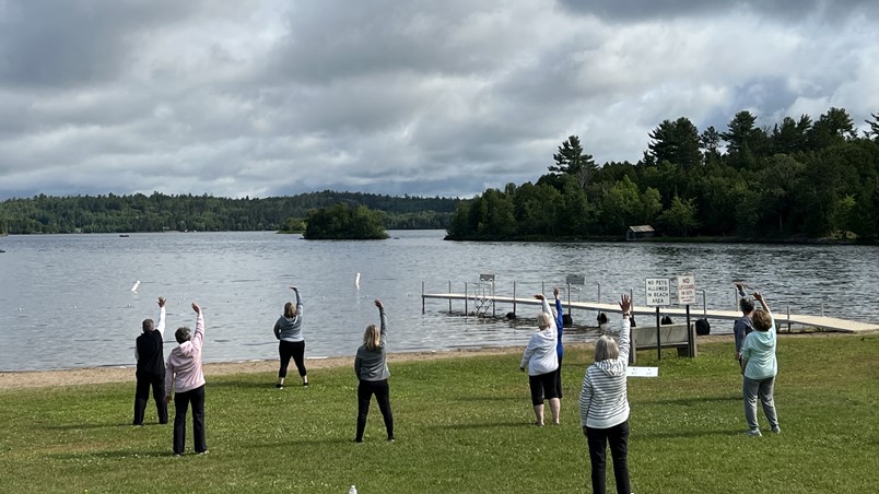 Participants in Tai Ji Quan class by the lake