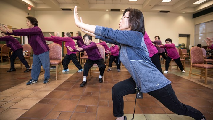 A class leader with participants in a Tai Ji Quan class.